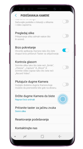 Dodirnite „Drži dugme Kamera da bi“